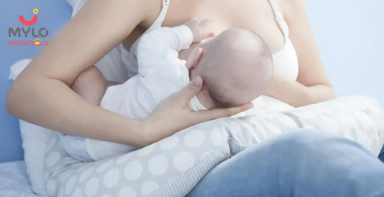 Is it safe for a new mother to use a pregnancy pillow while feeding her newborn?